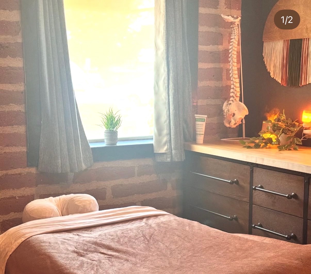 Massage table in a calm room with soft linens and warm lighting